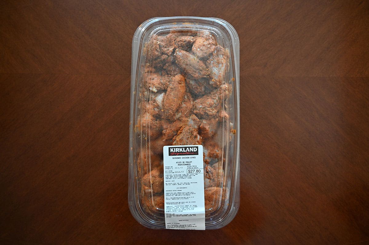 Costco Kirkland Signature Seasoned Chicken Wings container sitting on a table unopened, top down image.