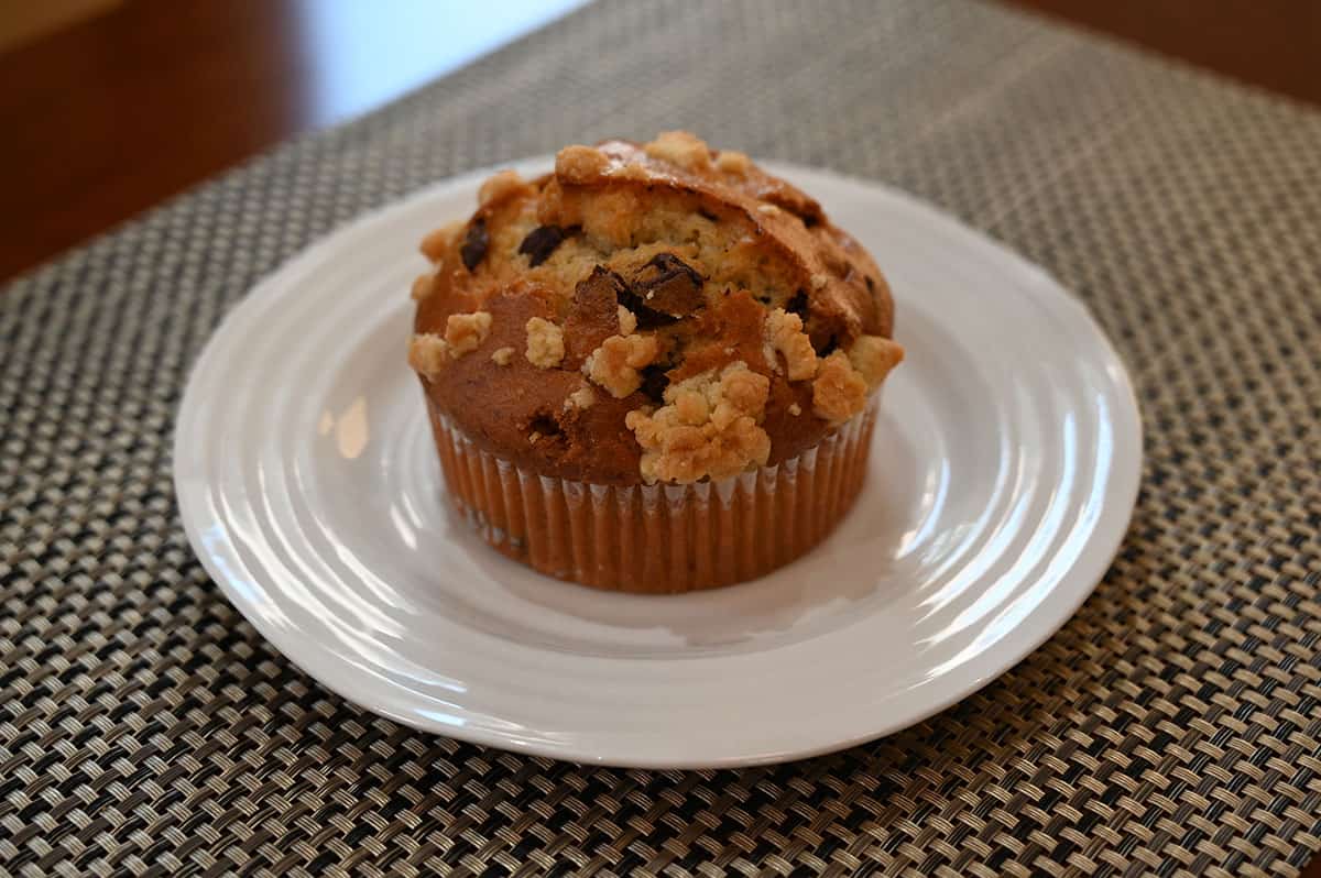 Image of one banana chocolate muffin on a white plate.