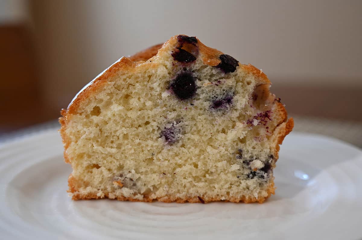 One blueberry muffin cut in half so you can see the inside.