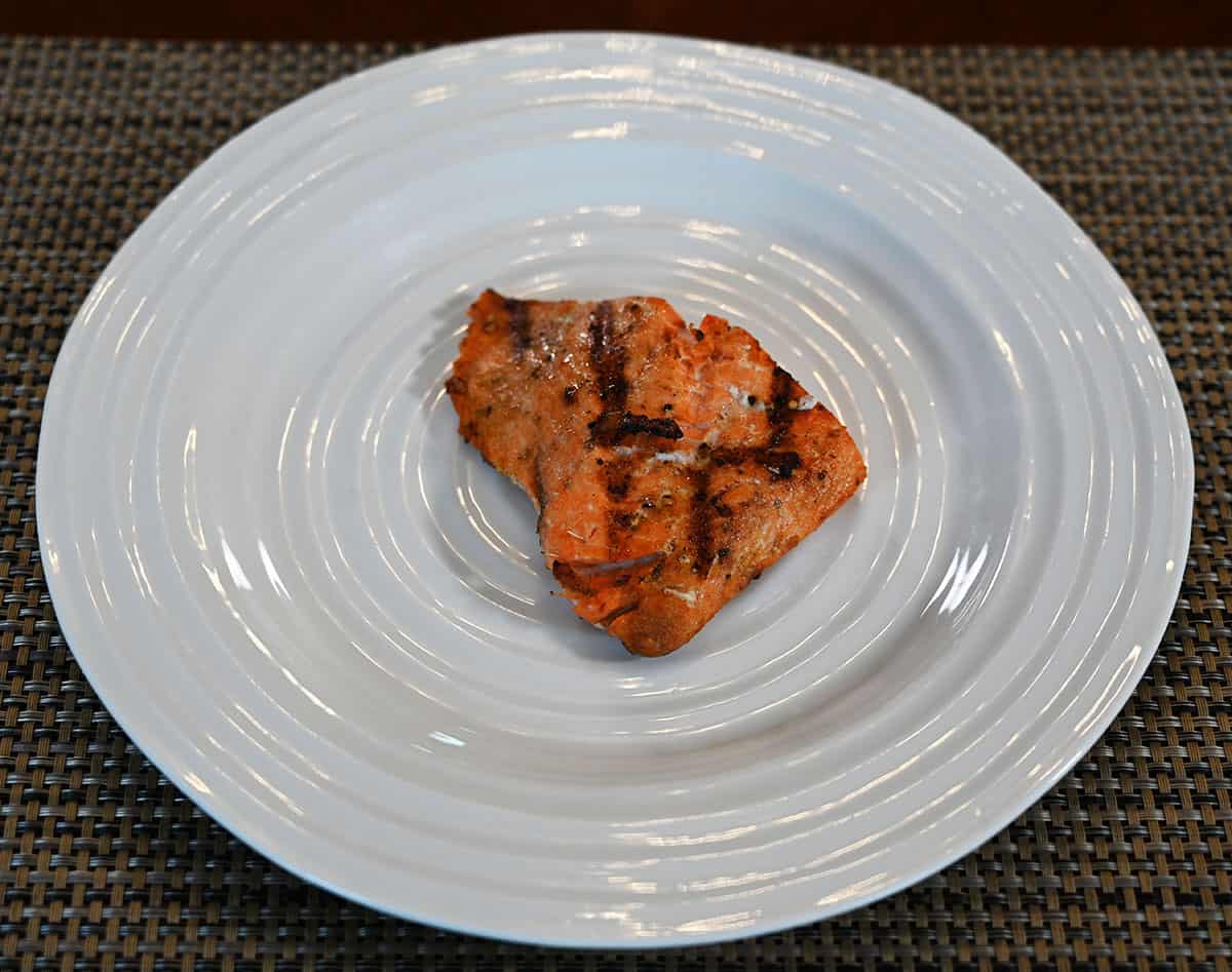 A piece of grilled salmon on a white plate.