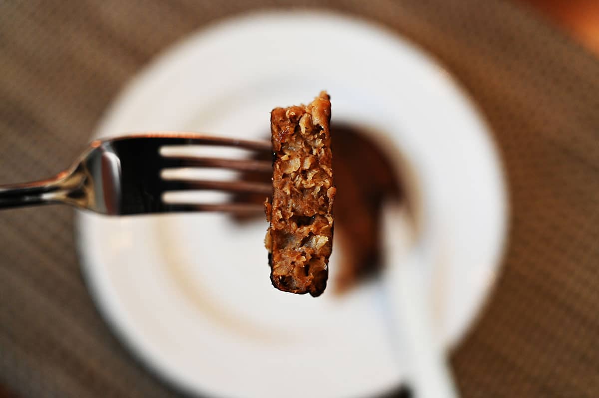 Closeup image of one bite of veggie burger on a fork so you can see the middle.