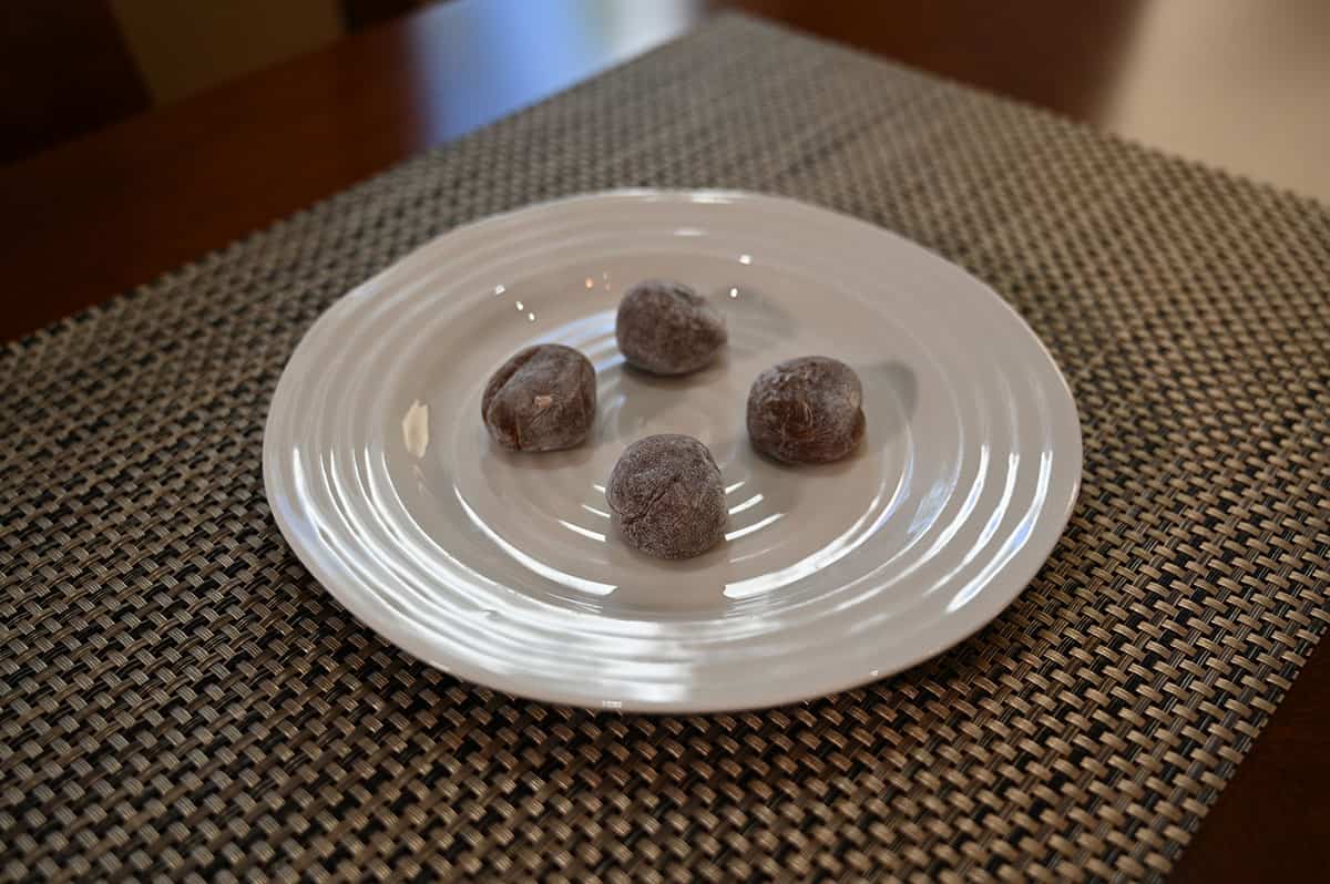 Image of a white plate with four mochi on it.