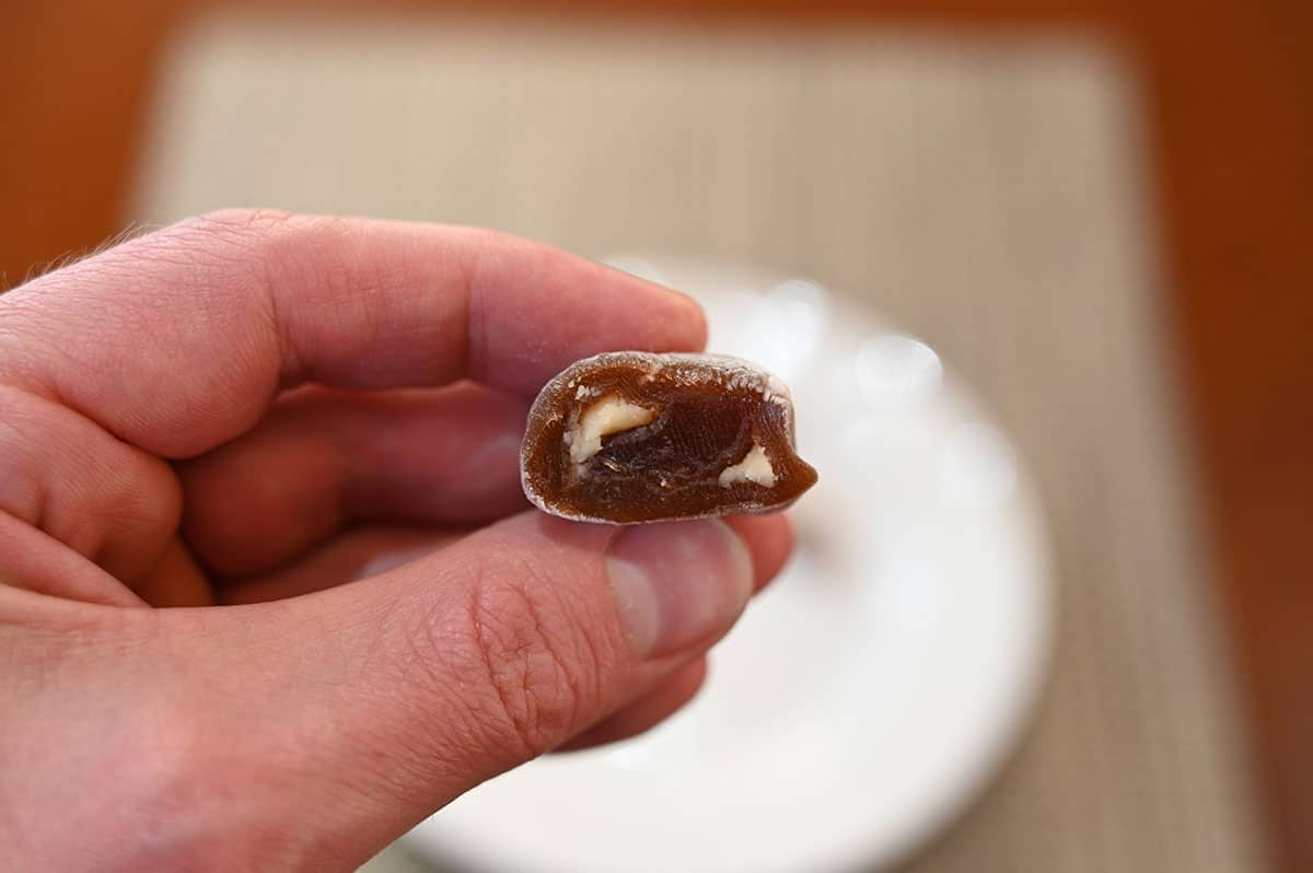 Closeup image of one mochi with a bite taken out so you can see the center.