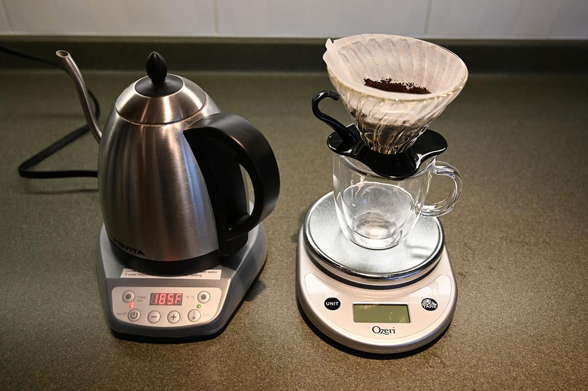 Image of coffee being made using a scale, kettle and special coffee filter. 