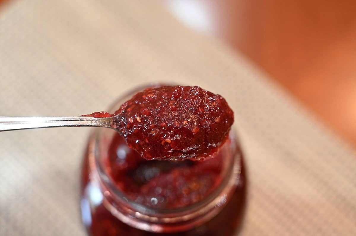 Closeup image of one spoonful of jam out of the jar.