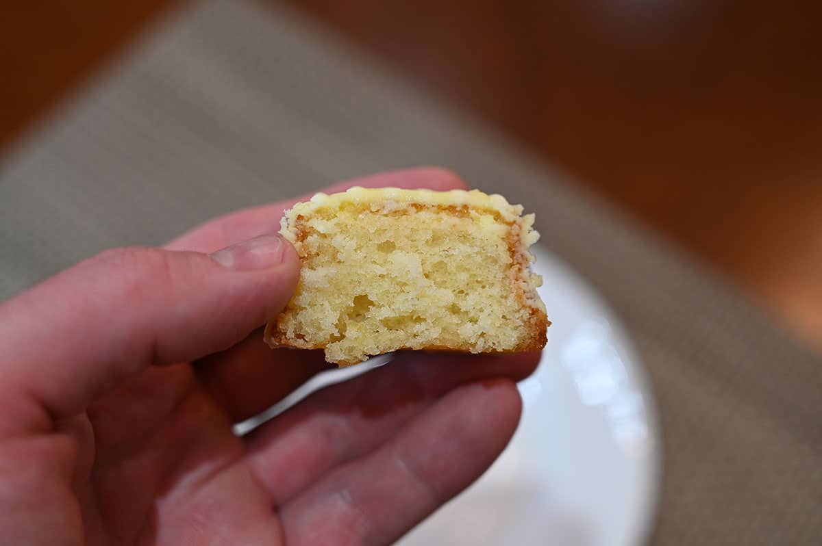 Side view closeup image of one lemon bite cut in half so you can see the middle.