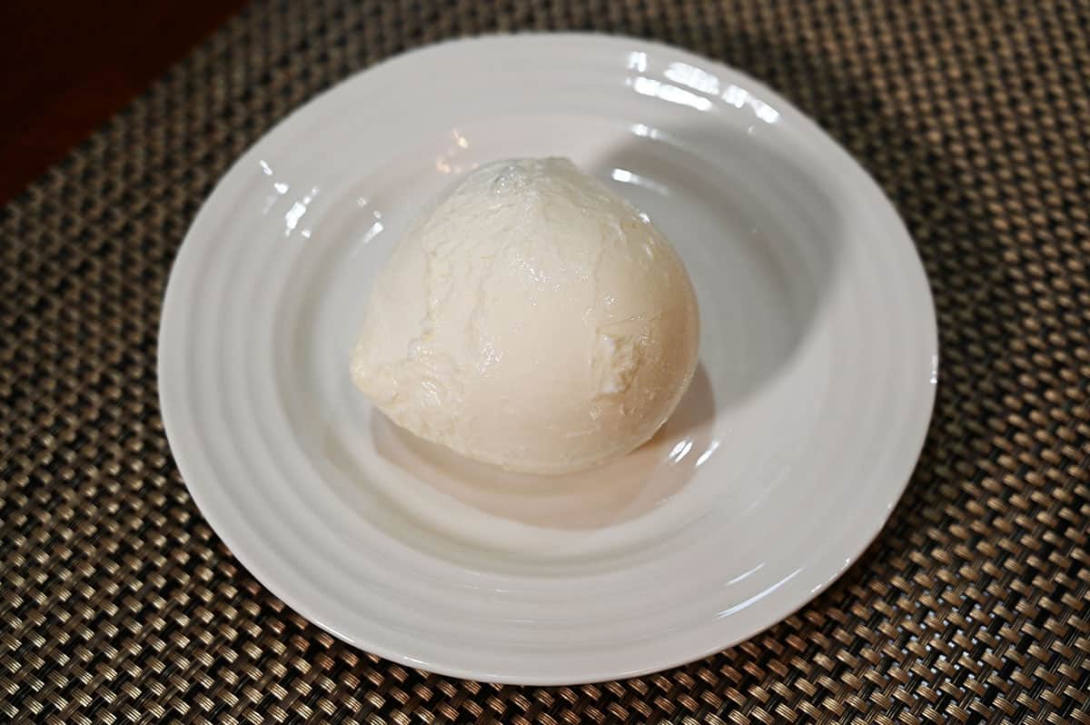 Image of a ball of mozzarella on a white plate.