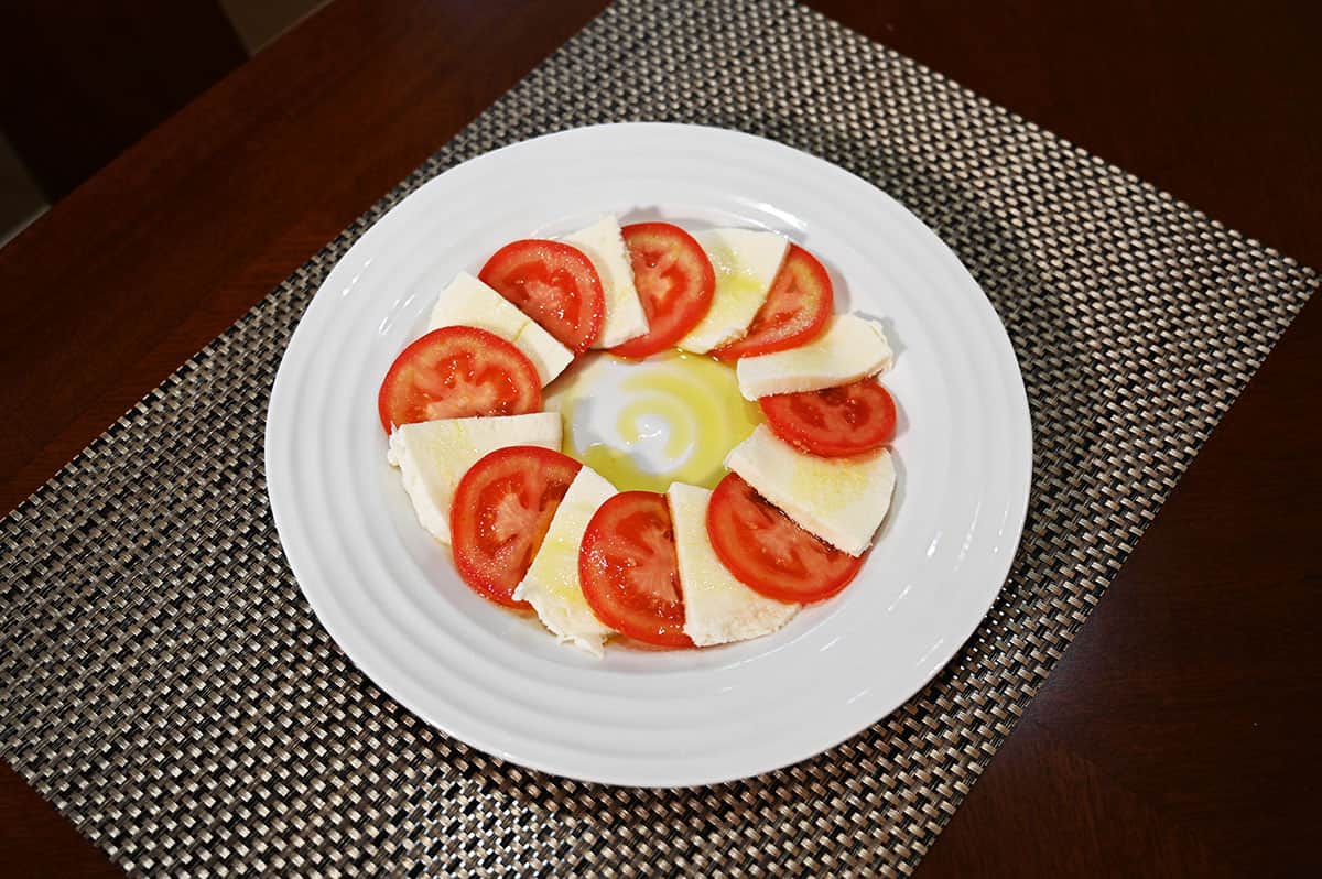 Image of a caprese salad served on a white plate.