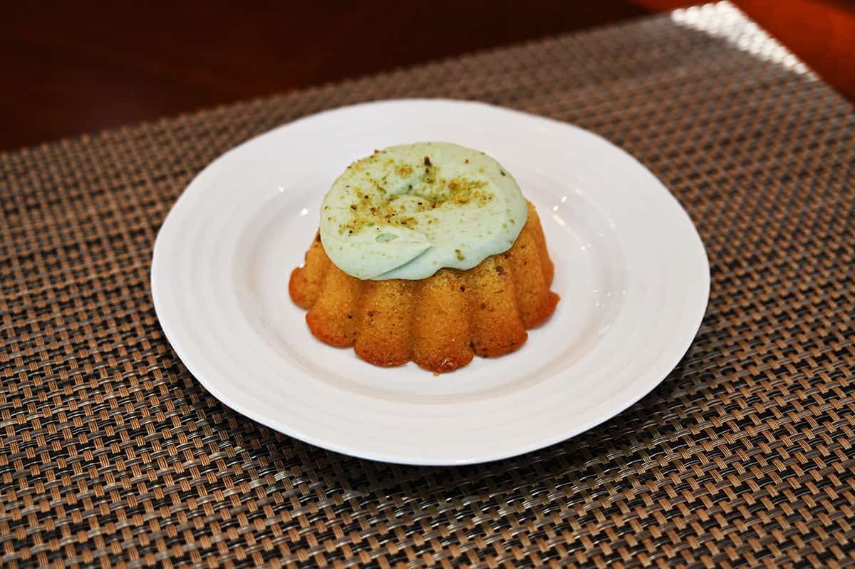 Image of one pistachio mini bundt on a plate.