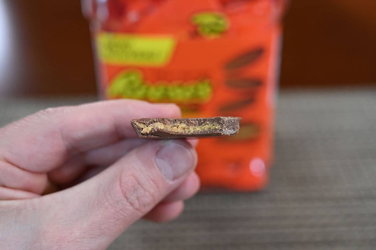 Image showing the inside of a Reese's Thins Peanut Butter Cup, showing the ratio of chocolate to peanut butter.