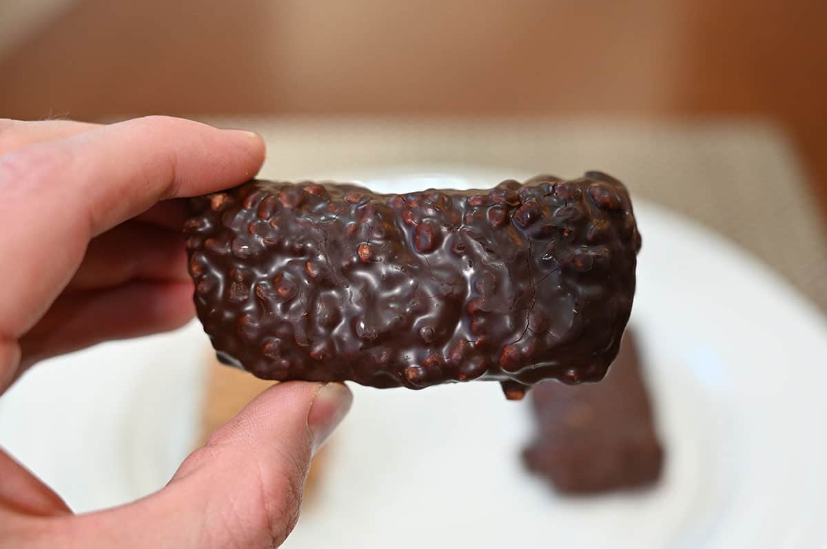 Closeup image of a hand holding the choco crisp bar.