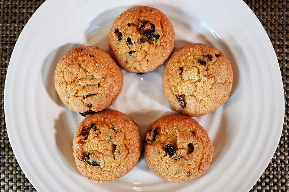 Top down image of five bisconie on a white plate.