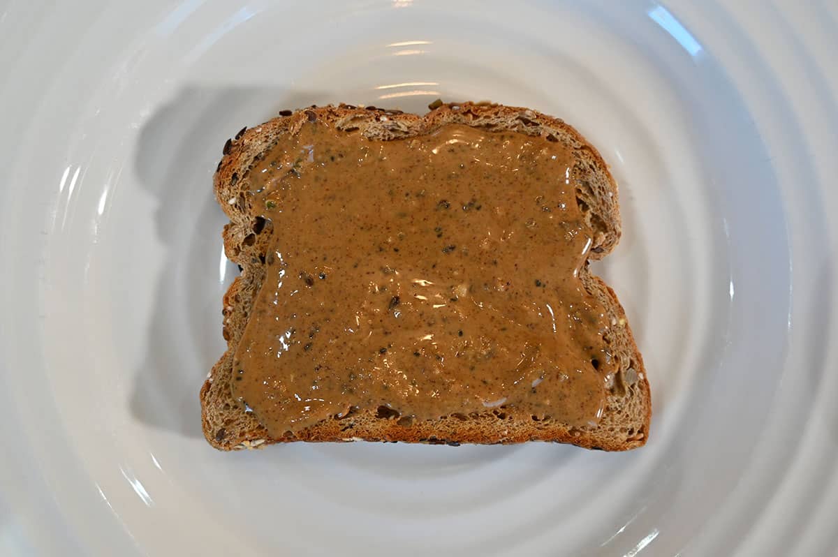 Image of a piece of toast with nut butter spread on it,