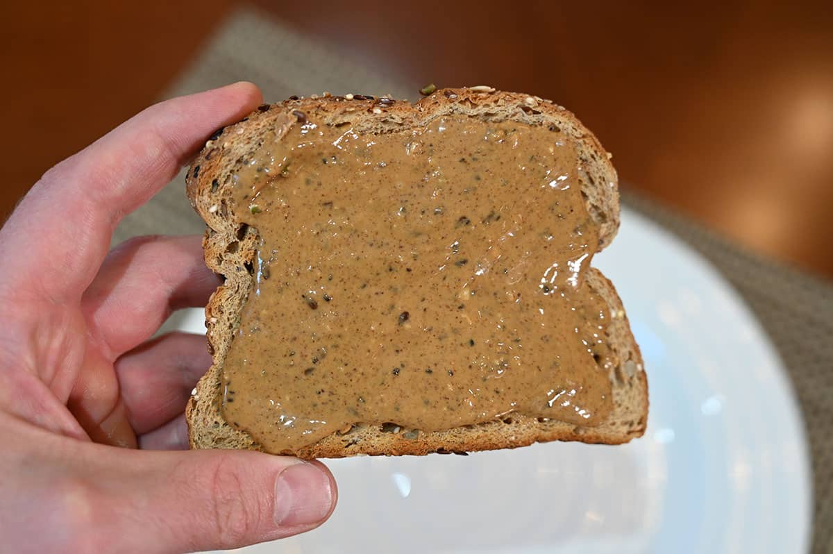 Closeup image of a piece of toast with nut butter spread on it,