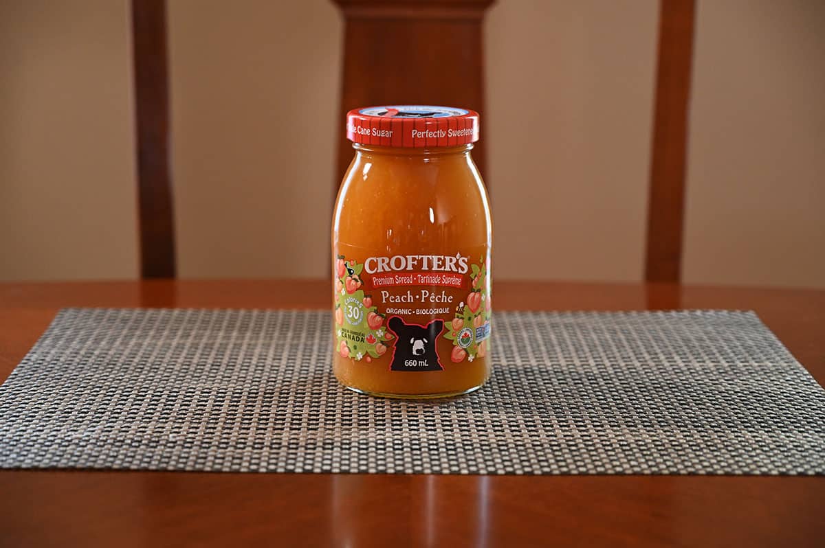 Costco Crofter's Peach Premium Spread jar sitting on a table.