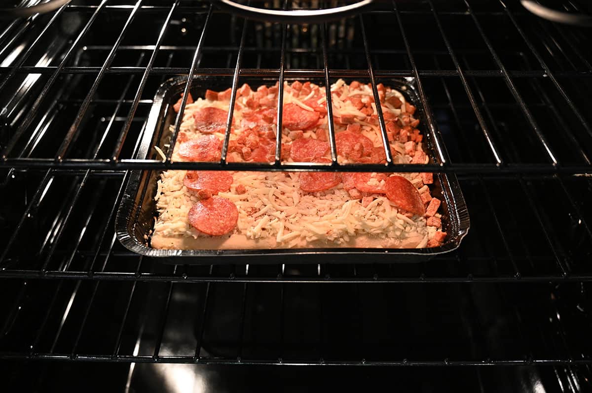 Image of the frozen pizza being cooked in the oven.
