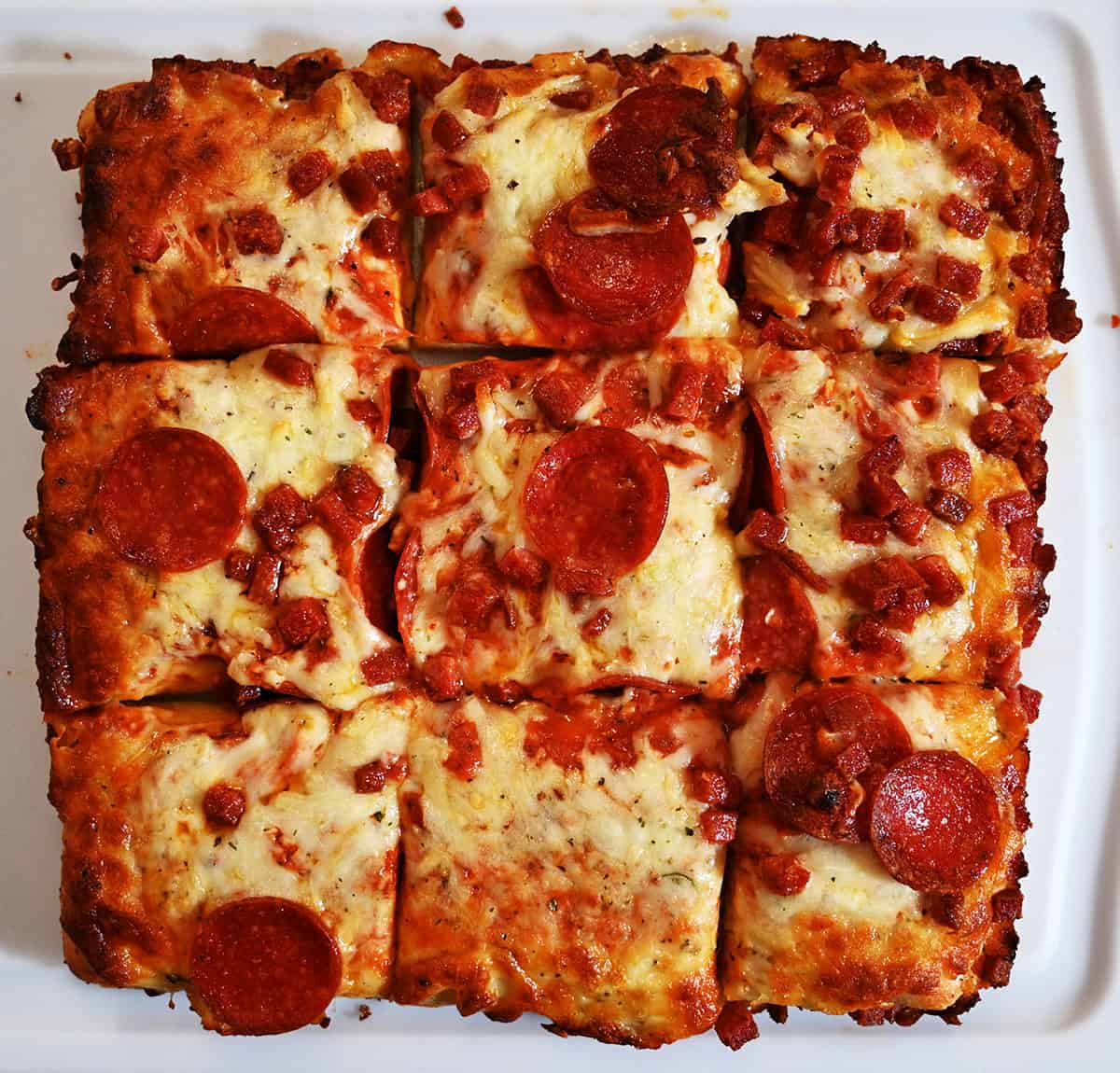 Closeup image of one pizza, cooked and sliced.