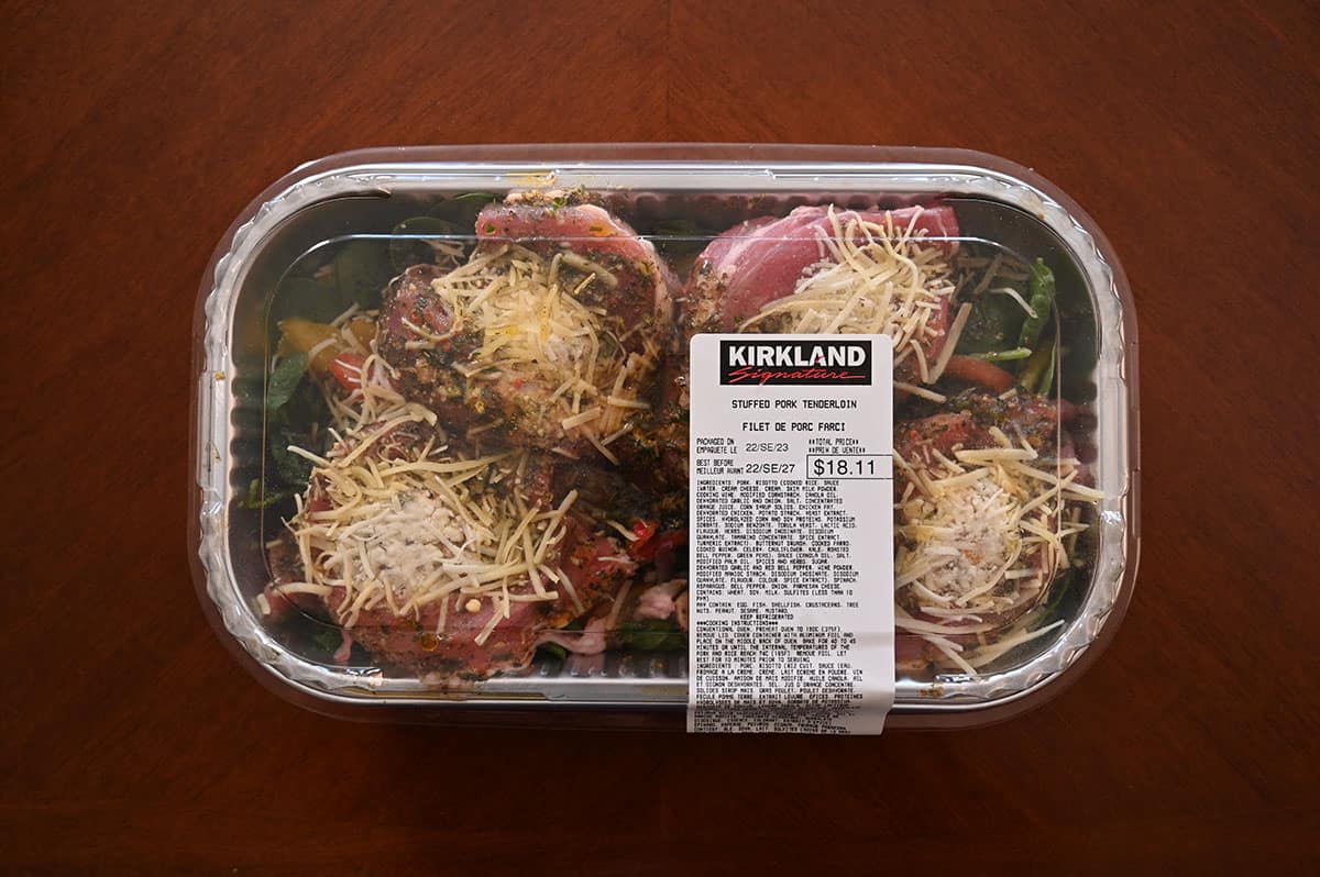 Image of the Costco Kirkland Signature Stuffed Pork Tenderloin in the package on a table, top down image.