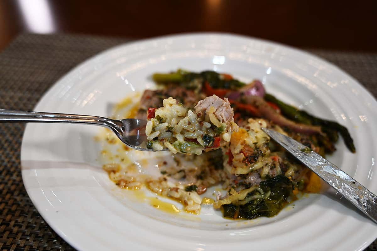 Top down image of the pork tenderloin meal on a white plate with bites taken from it.