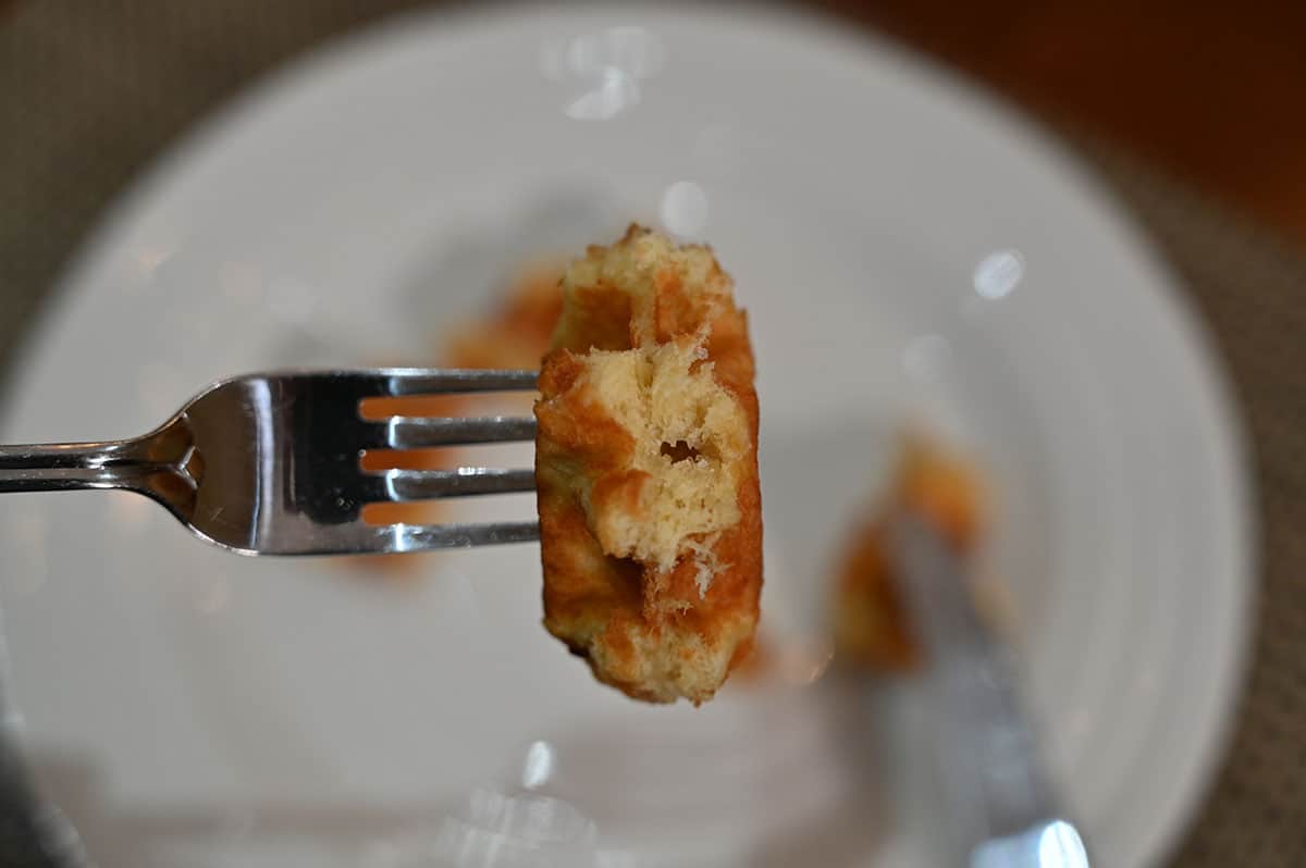 Closeup image of one bite of waffle on a fork.