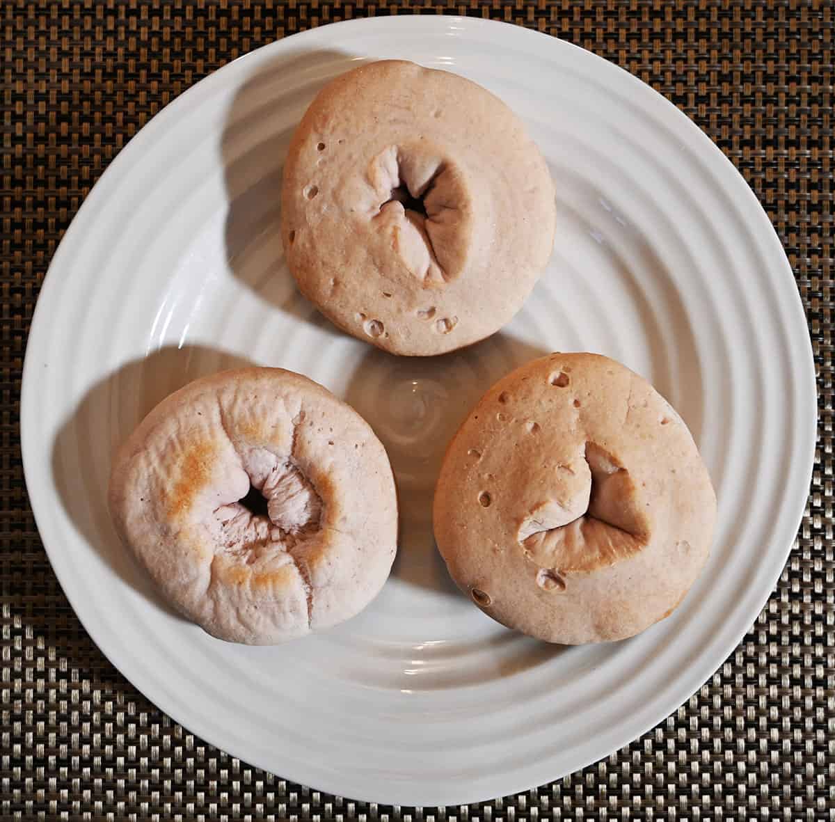 Image showing three bagels on a white plate.
