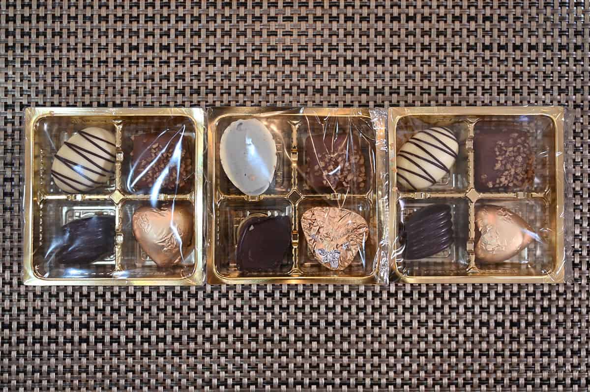 Image showing the three small trays of chocolates that come in one box of chocolates. Four chocolates are in each box and the trays are sitting on a table.