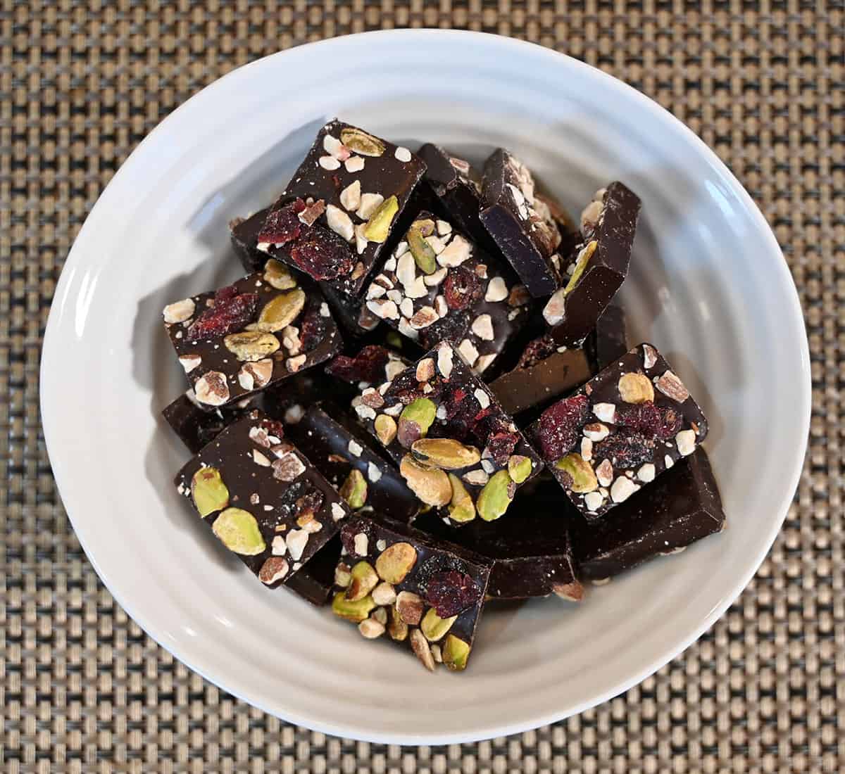 Closeup image of a bowl full of dark chocolate bites.