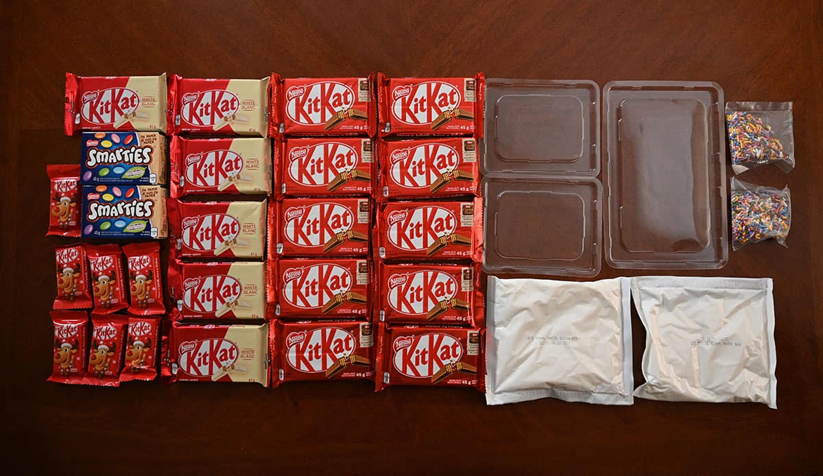 Image of all the contents of the Kit Kat Cabin & Hut building kit sitting on a table.
