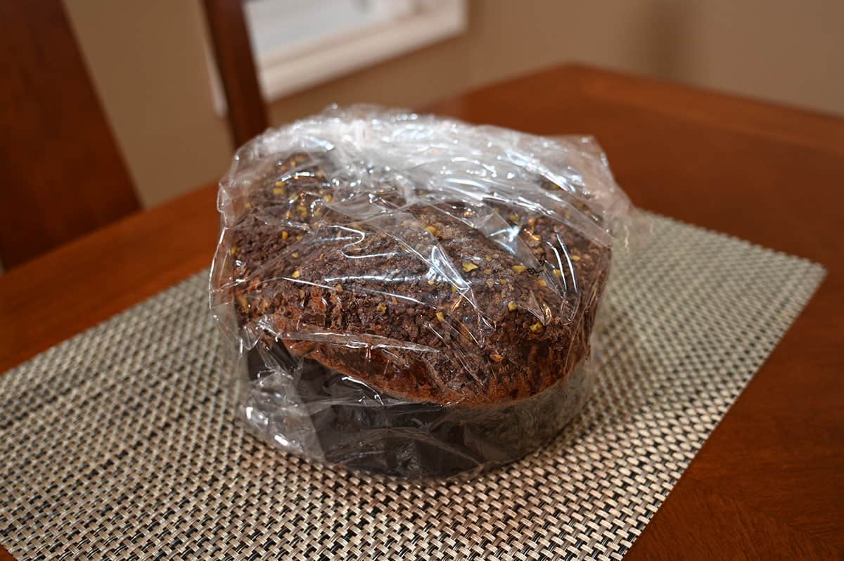 Image of the panettone wrapped in cellophane and sitting on a table.