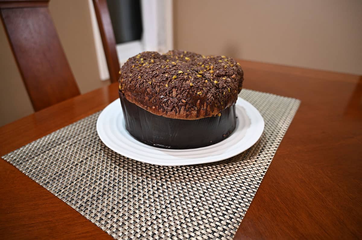 Image of the Costco panettone out of the package, the whole panettone is sitting on a white plate.
