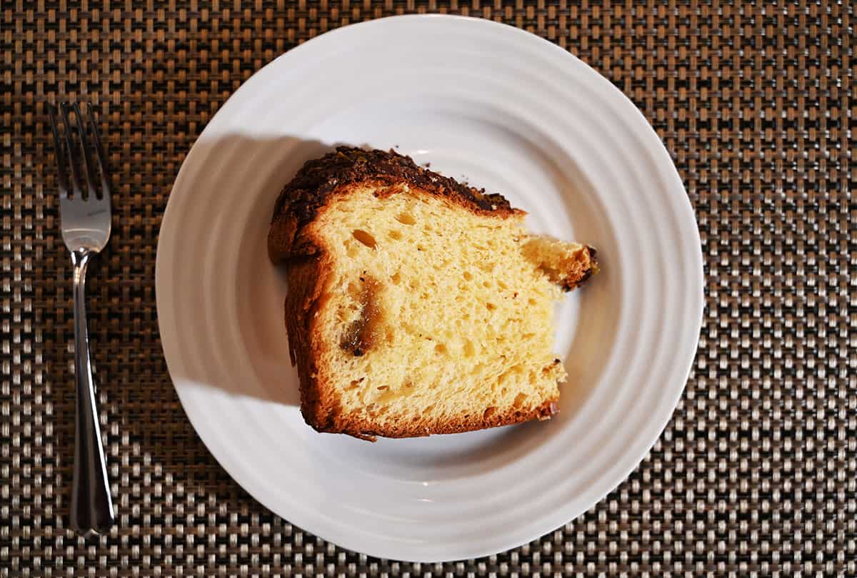 Image of one slice of panettone on a white plate.