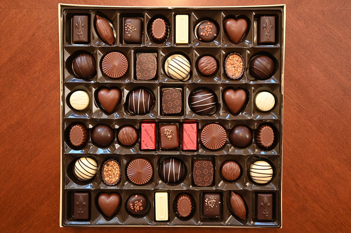 Top down image of the box of chocolates opened so you can see each kind all sitting in the box.