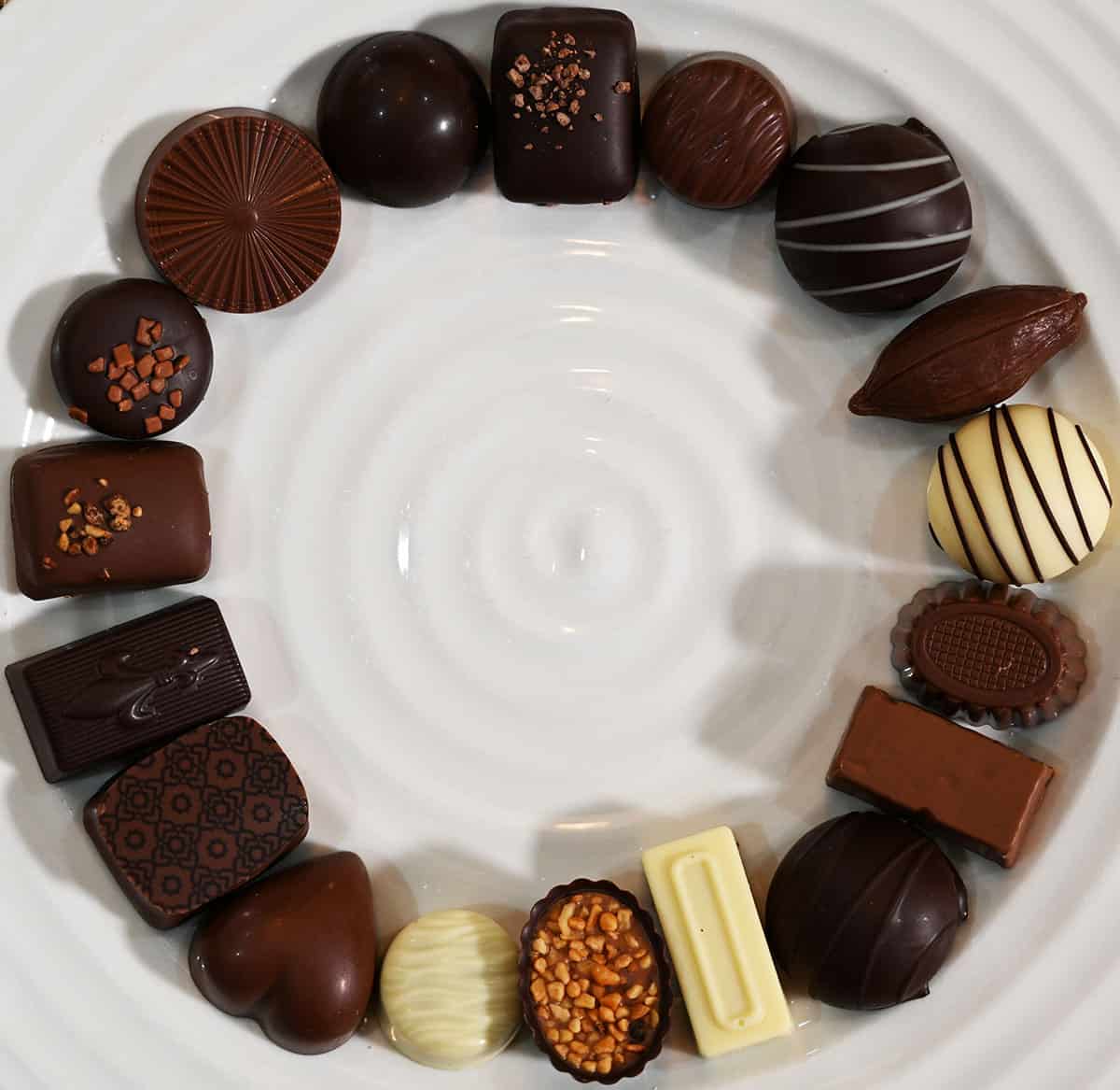 Image of all the different kinds of chocolate on a white plate served in a circle.