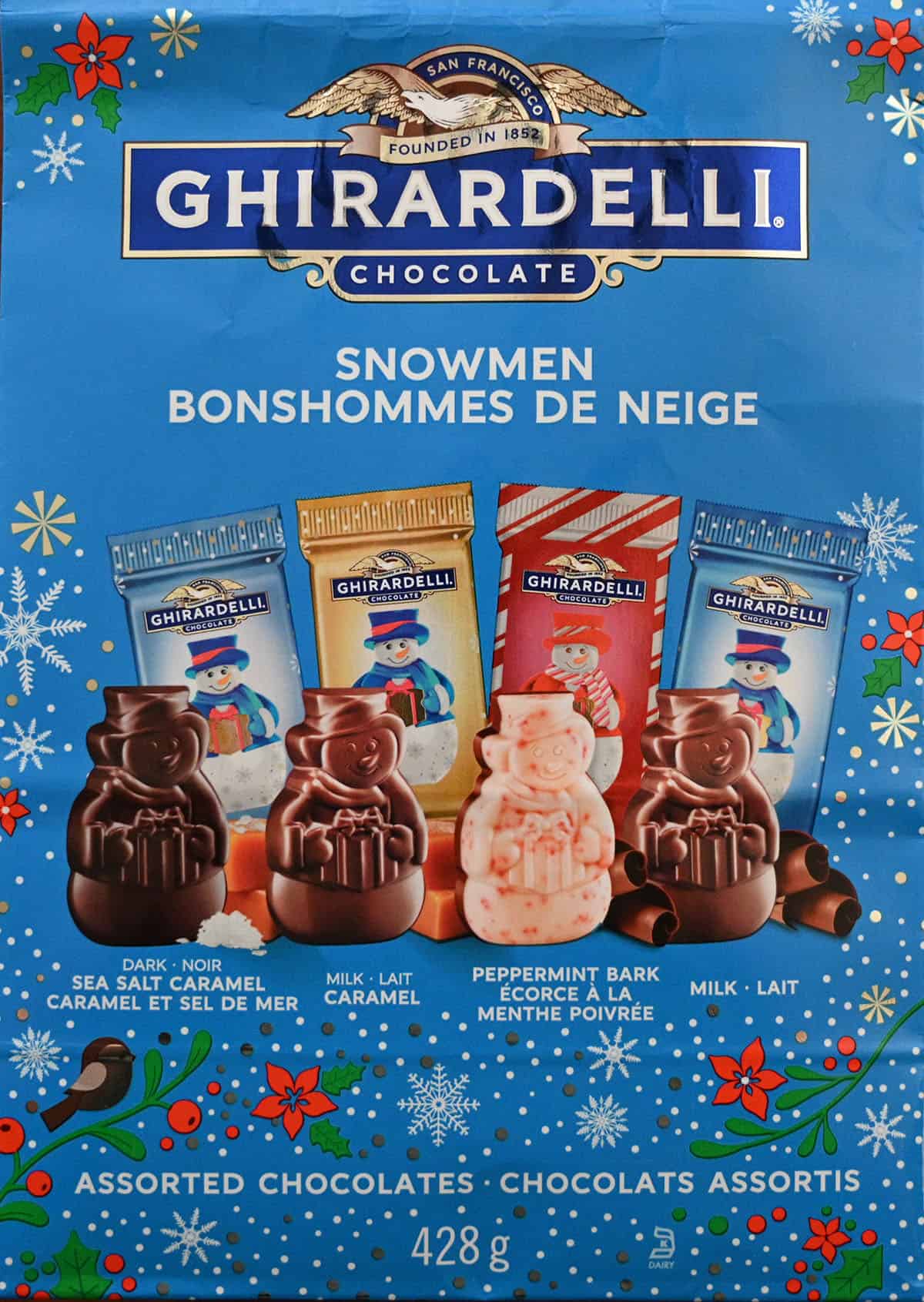 Closeup image of the front of the bag of chocolate snowmen showing the weight of the bag and four flavors of snowmen.