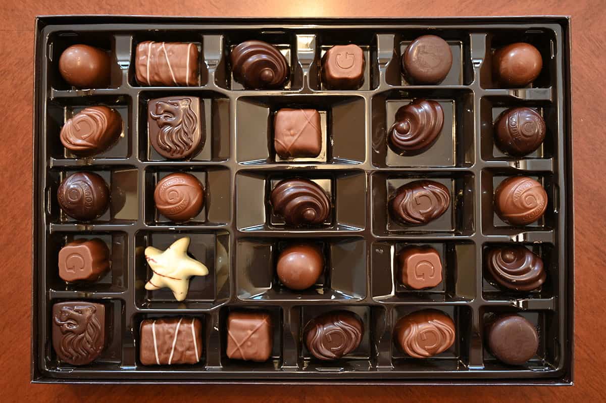 Top down image of all the chocolates in the box with the lid off.