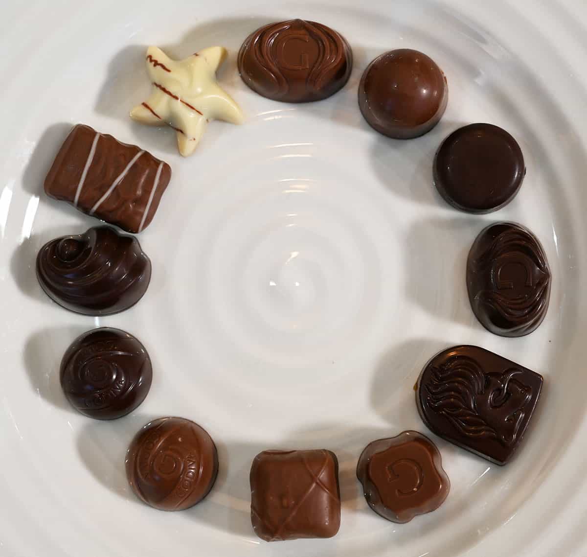 Image of all 12 different kinds of chocolates from the box in a circle.