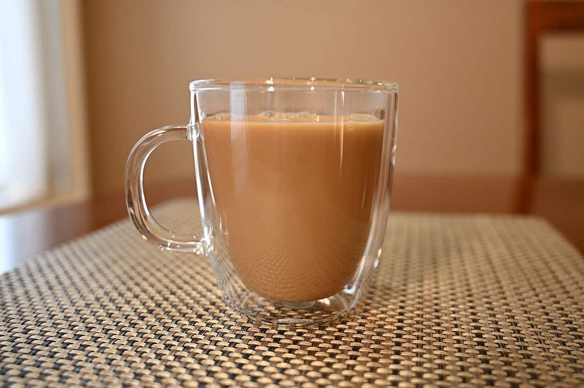 Image of a cup of coffee sitting on a table with Irish cream in the coffee.