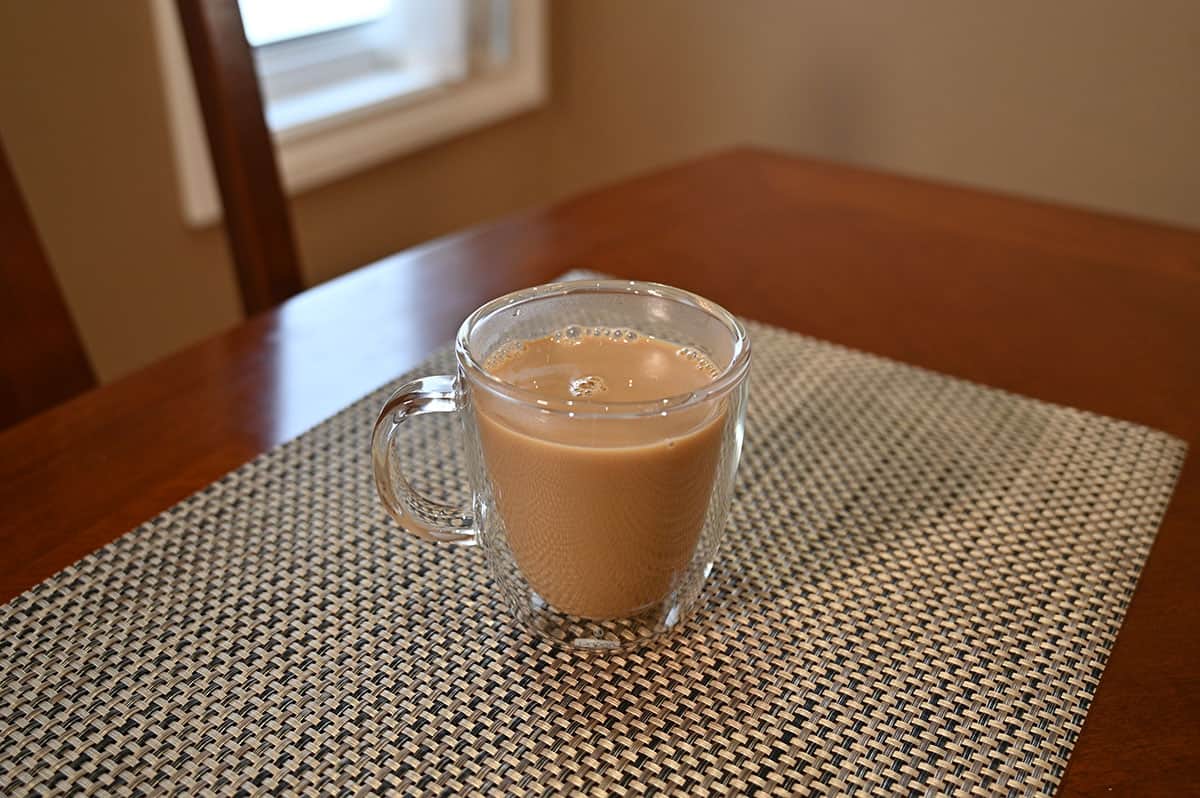 Image of a cup of coffee sitting on a table with Irish cream in the coffee.