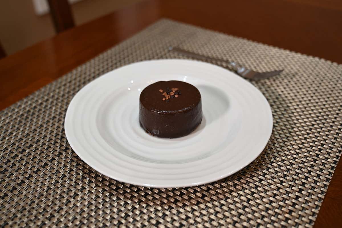 Image of one chocolate mousse sitting on a white plate.