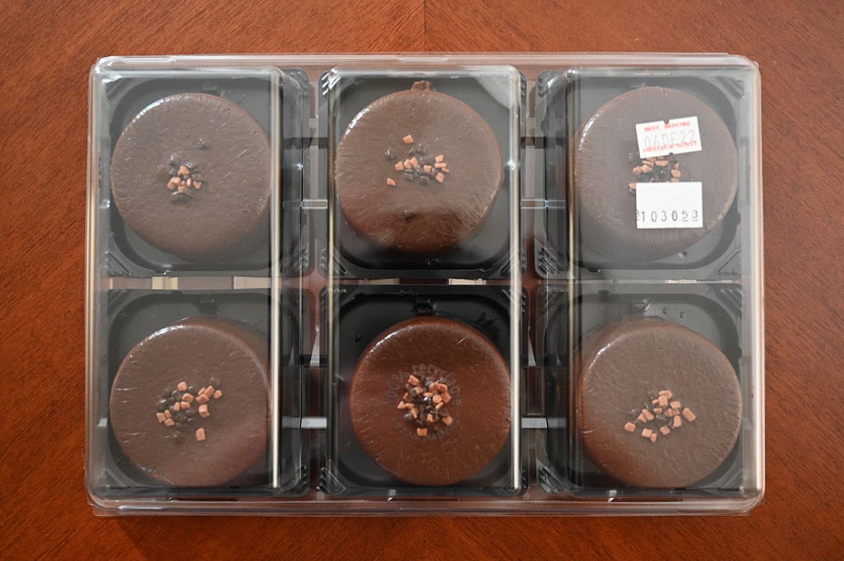 Top down image of the six mousses in the package with the clear plastic lid on.