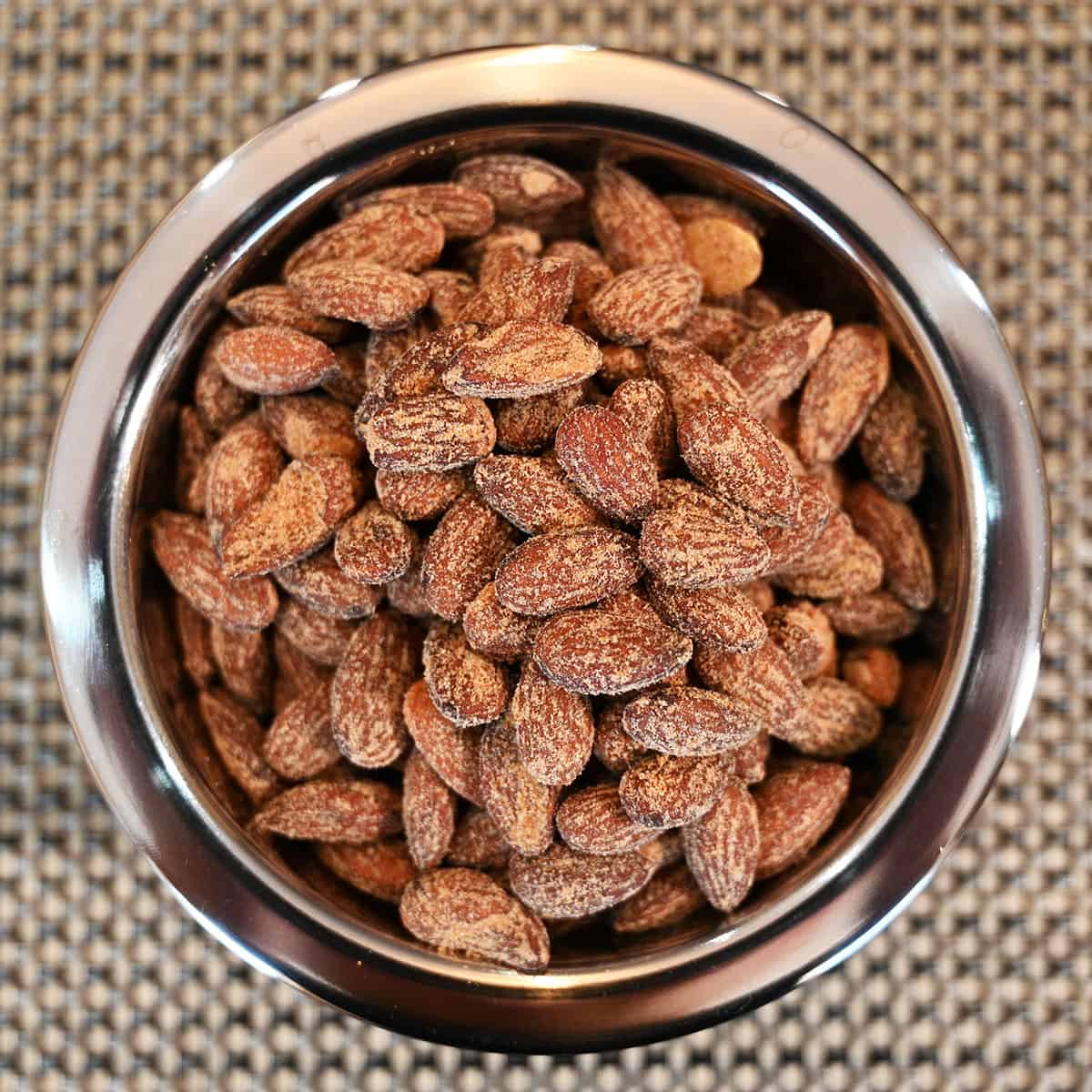 Top down image of a metal bowl full of the almonds.