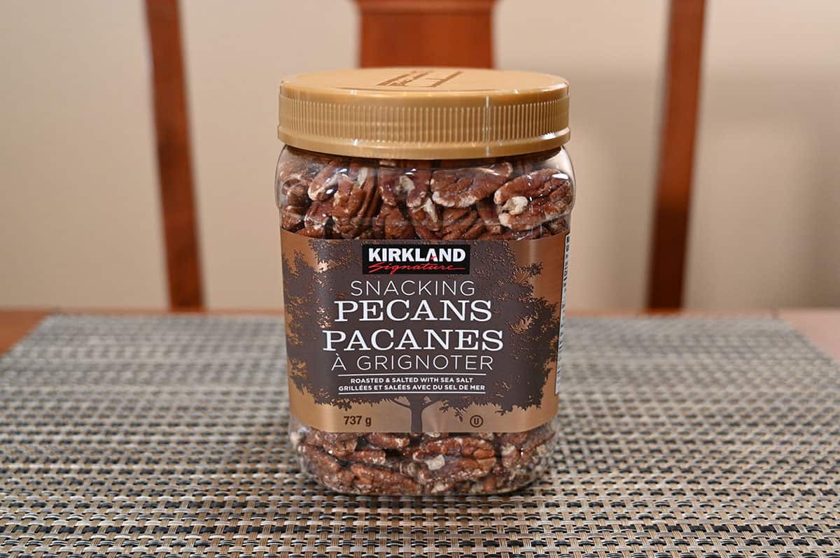 Image of the Costco Kirkland Signature Snacking Pecans container sitting on a table.