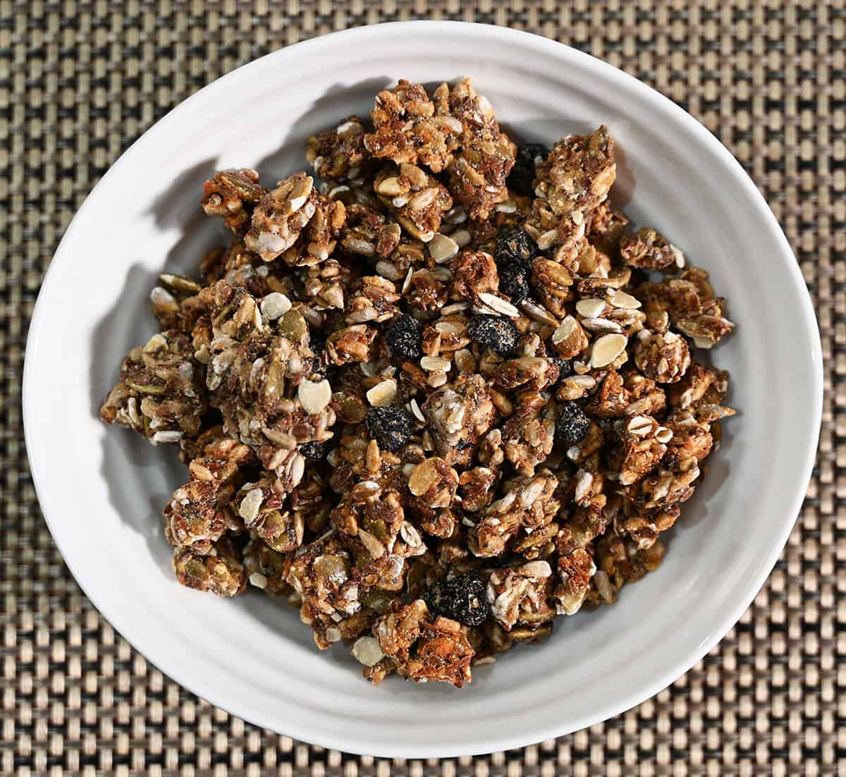 Top down image of a white bowl filled with granola.
