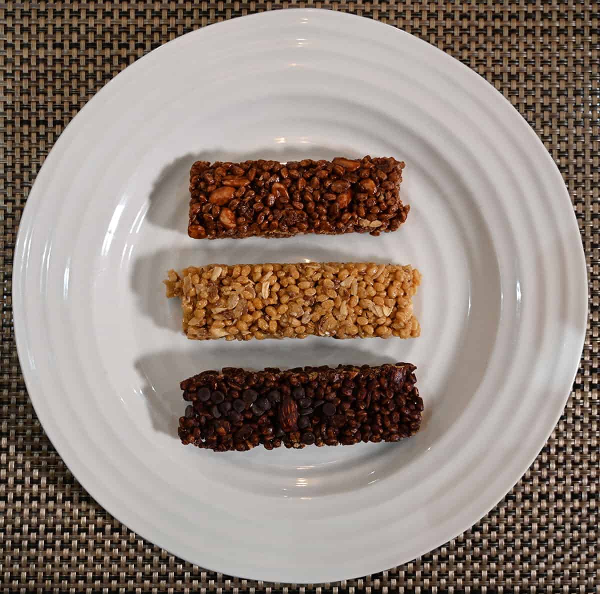 Image of the three different flavors of protein bars out of the wrapper and served on a white plate.