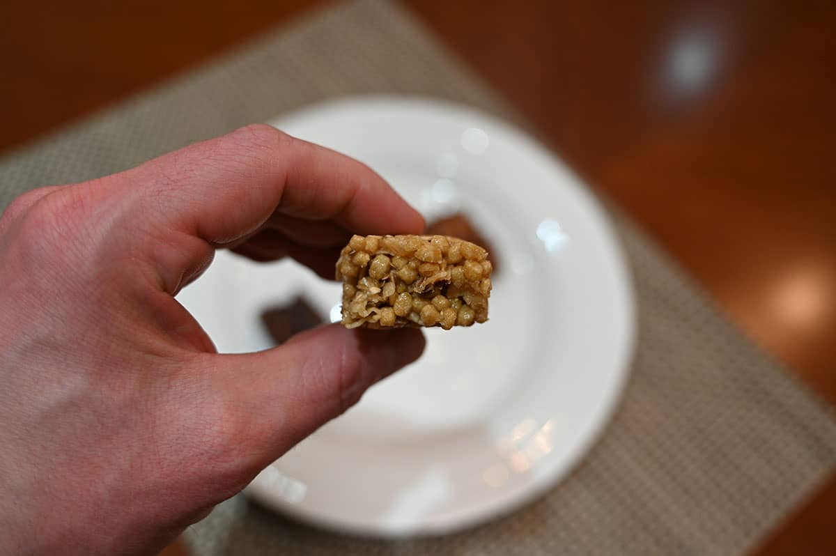 Image of the lemon coconut bar, unwrapped with a bite taken out of it.