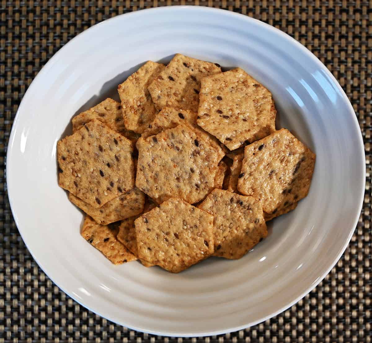 Top down image of a white bowl full of crackers.