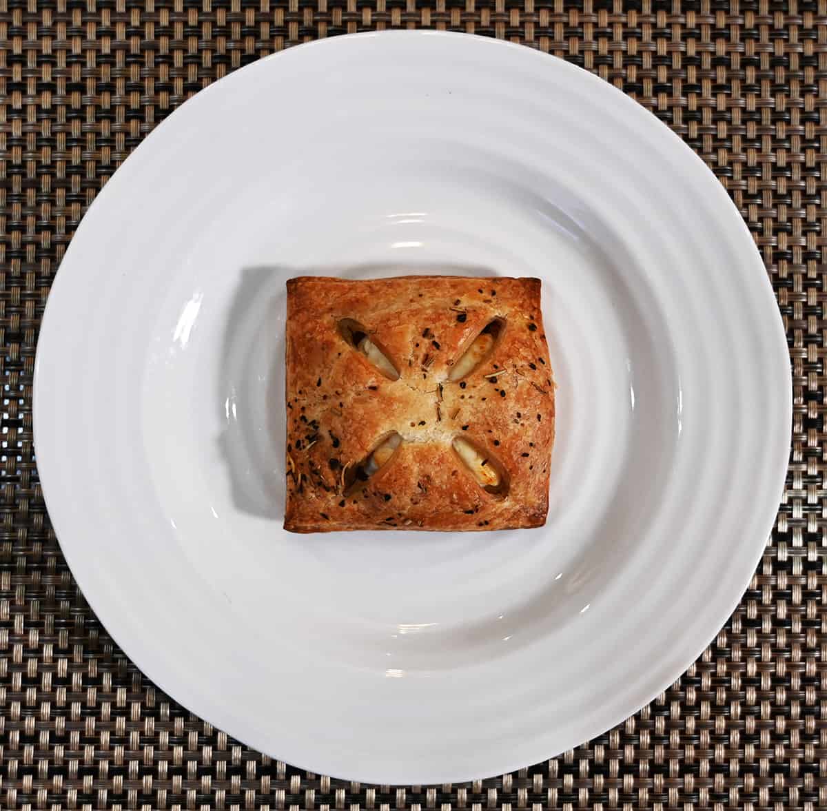Top down image of one puff pastry baked and served on a white plate.
