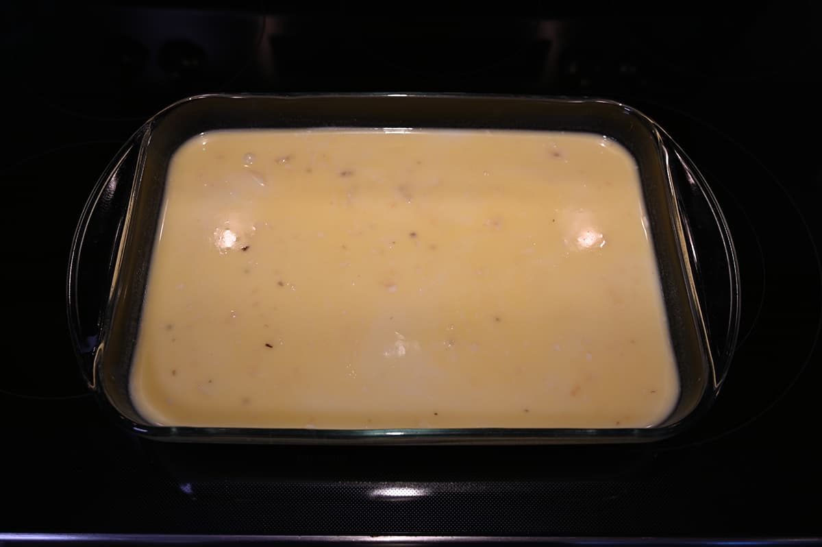 Image of a casserole dish showing the potatoes prepared but not yet baked.