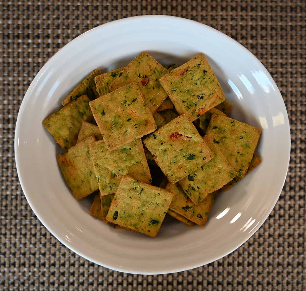 Top down image of a white bowl full of the crackers.