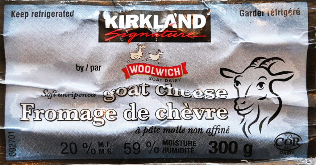 Closeup image of the front label of the Costco Kirkland Signature Goat Cheese showing it's 20% milk fat and needs to be kept refrigerated.